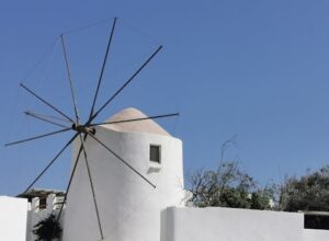 Traditional Greek windmill on a sunny day in Antiparos, perfect for travel inspiration.